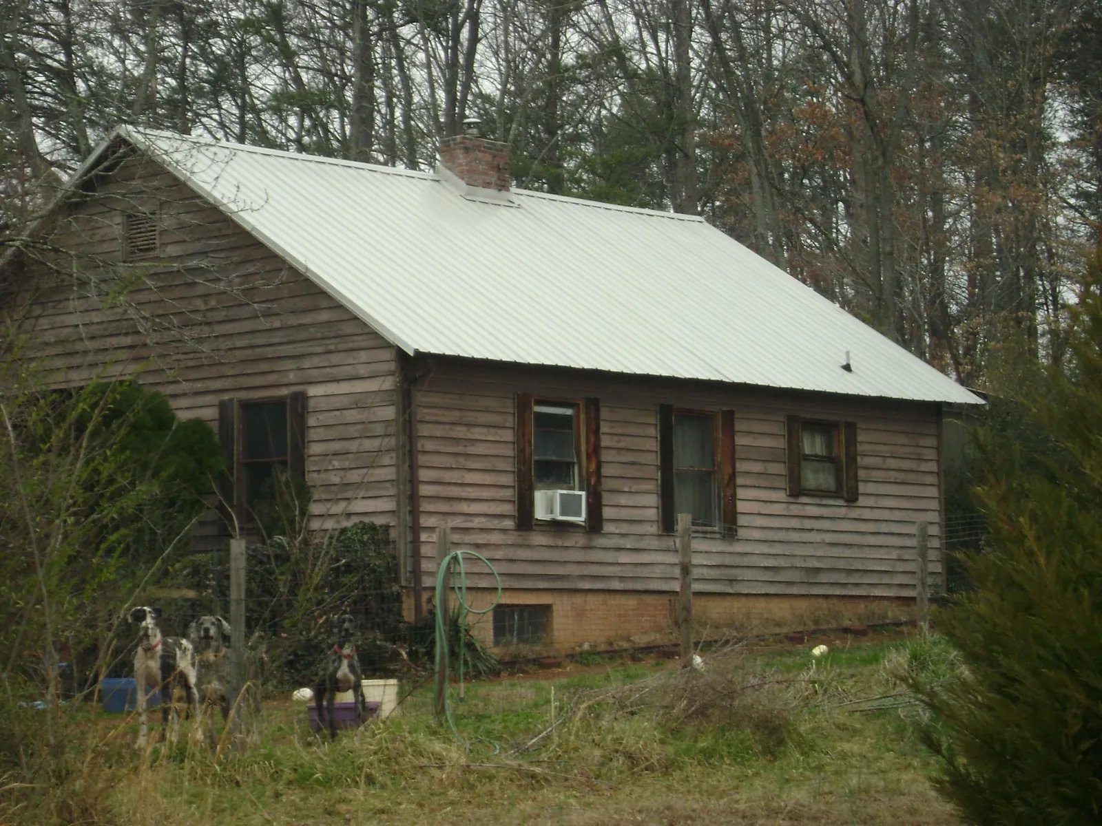 White metal roof on an old wood sided farmhouse, from a Metal Roof Installation job in Abbeville